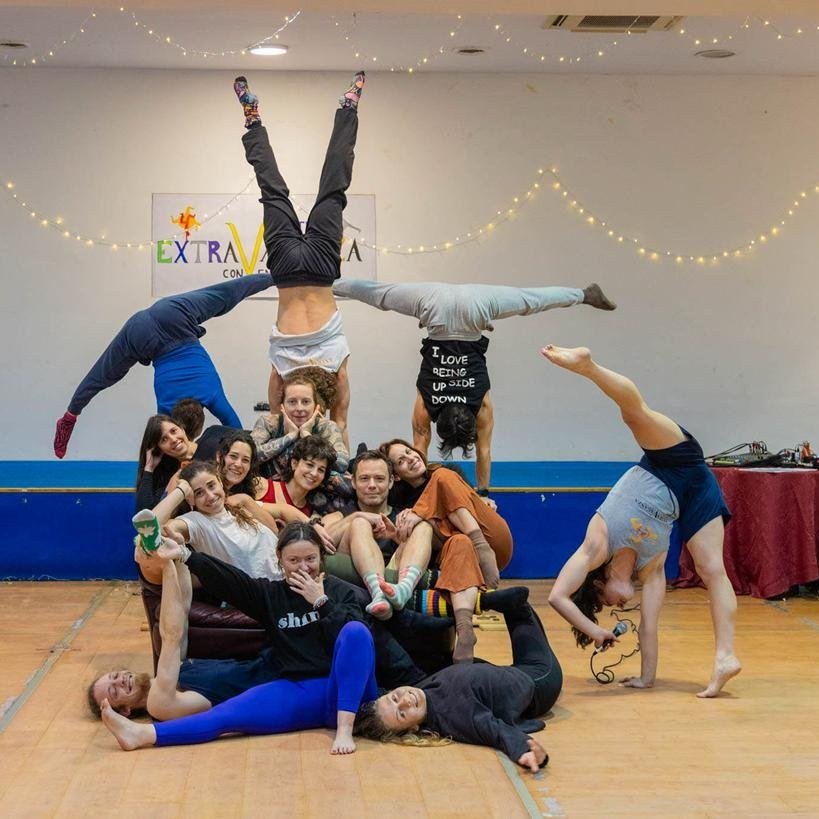 Group photo at Winter Extravaganza: participants doing handstands and contortion poses together